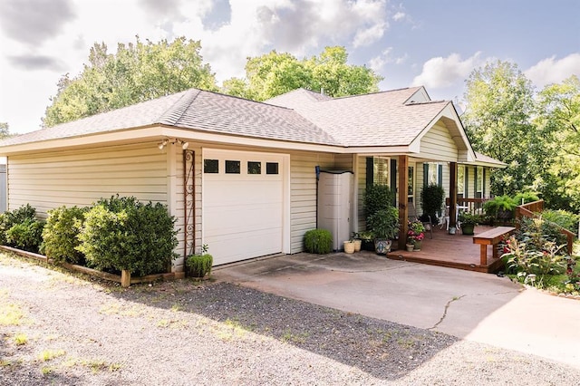 207 S Mcclure Ave, Pauls Valley, OK 73075 - single story home featuring a garage, driveway, roof with shingles, and a porch