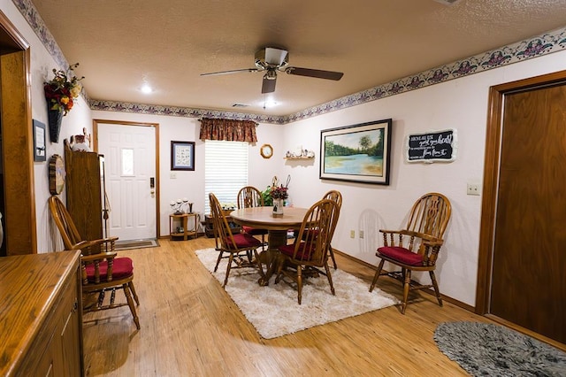 207 S Mcclure Ave, Pauls Valley, OK 73075 - dining area featuring light wood-type flooring, ceiling fan, and a textured ceiling
