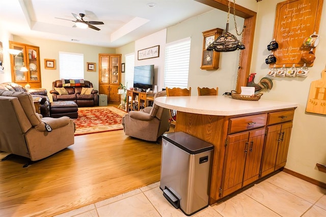 207 S Mcclure Ave, Pauls Valley, OK 73075 - kitchen featuring open floor plan, refrigerator, a ceiling fan, light countertops, and a raised ceiling