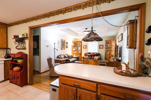 207 S Mcclure Ave, Pauls Valley, OK 73075 - kitchen featuring light countertops, open floor plan, white dishwasher, and a ceiling fan