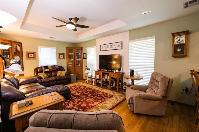 207 S Mcclure Ave, Pauls Valley, OK 73075 - living room with a raised ceiling, a ceiling fan, and wood finished floors