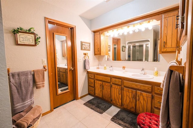 207 S Mcclure Ave, Pauls Valley, OK 73075 - full bath with double vanity, tile patterned flooring, and a textured wall