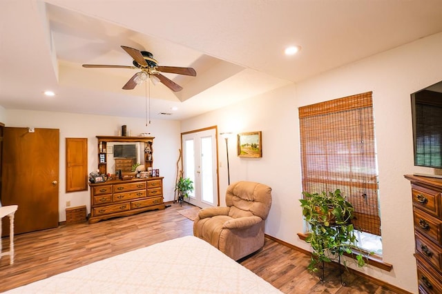 207 S Mcclure Ave, Pauls Valley, OK 73075 - bedroom featuring wood finished floors, a tray ceiling, recessed lighting, access to exterior, and ceiling fan