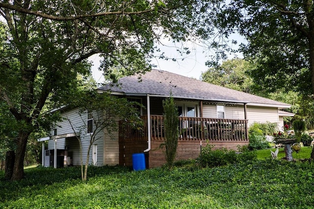 207 S Mcclure Ave, Pauls Valley, OK 73075 - rear view of property with roof with shingles