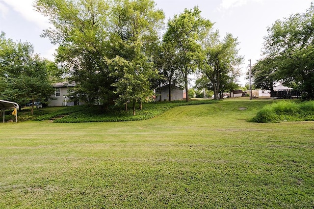 207 S Mcclure Ave, Pauls Valley, OK 73075 - view of grassy yard with a carport