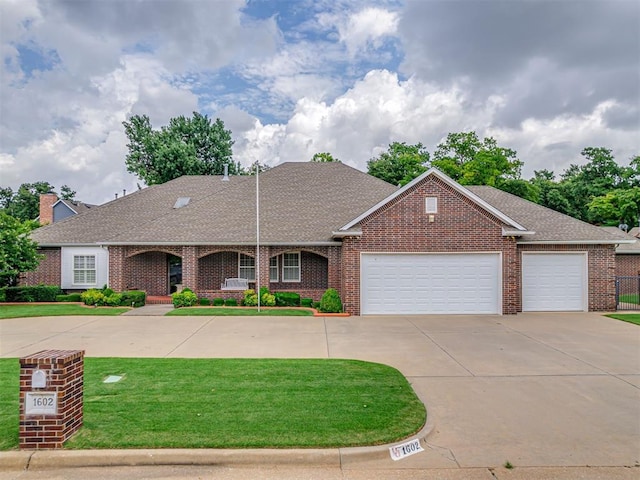 1602 N Davis Ave, Oklahoma City, OK 73127 - view of front of house with brick siding, an attached garage, concrete driveway, and a front yard