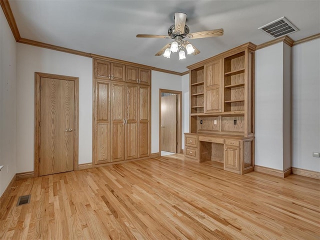 1602 N Davis Ave, Oklahoma City, OK 73127 - unfurnished living room featuring built in desk, light wood-style floors, ceiling fan, and ornamental molding
