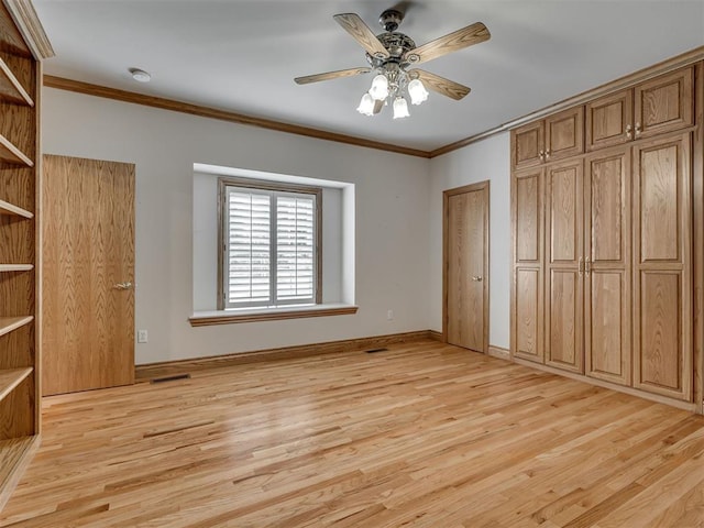 1602 N Davis Ave, Oklahoma City, OK 73127 - unfurnished bedroom with light wood-type flooring, multiple closets, ornamental molding, and ceiling fan