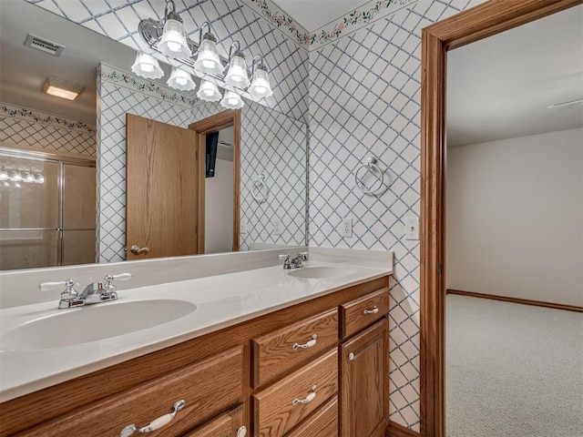 1602 N Davis Ave, Oklahoma City, OK 73127 - bathroom with wallpapered walls, double vanity, a shower with shower door, and a chandelier