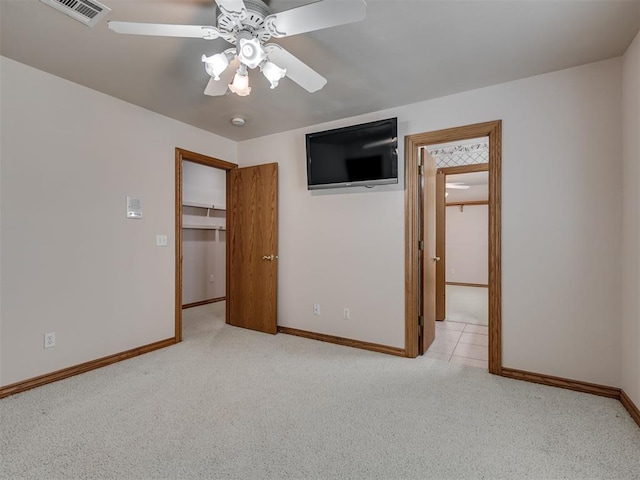 1602 N Davis Ave, Oklahoma City, OK 73127 - unfurnished bedroom featuring carpet flooring, a ceiling fan, and a walk in closet