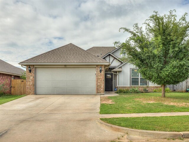 8612 SW 36th Ter, Oklahoma City, OK 73179 - view of front of house with brick siding, an attached garage, concrete driveway, and roof with shingles