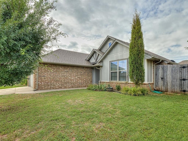 8612 SW 36th Ter, Oklahoma City, OK 73179 - view of front of home featuring brick siding, concrete driveway, a garage, and board and batten siding