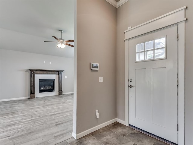 8612 SW 36th Ter, Oklahoma City, OK 73179 - foyer with ceiling fan, a glass covered fireplace, and crown molding