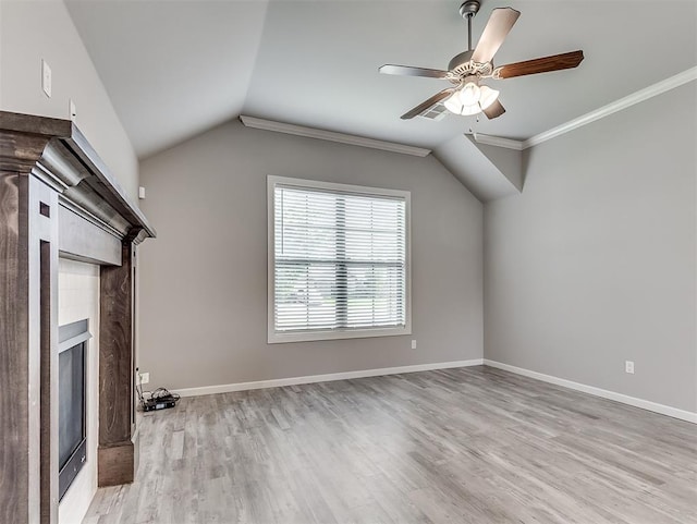 8612 SW 36th Ter, Oklahoma City, OK 73179 - unfurnished living room featuring a fireplace, light wood-style floors, lofted ceiling, ceiling fan, and crown molding