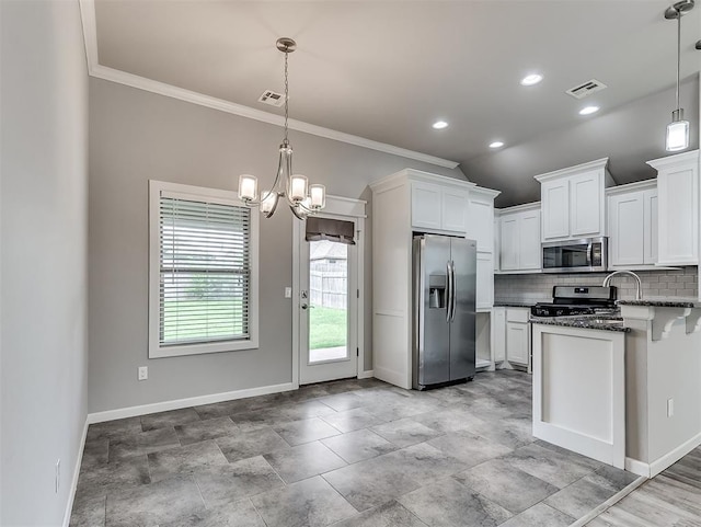 8612 SW 36th Ter, Oklahoma City, OK 73179 - kitchen with stainless steel appliances, decorative backsplash, white cabinetry, a chandelier, and ornamental molding