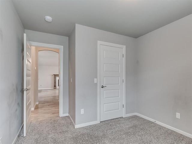 8612 SW 36th Ter, Oklahoma City, OK 73179 - unfurnished bedroom with arched walkways and carpet