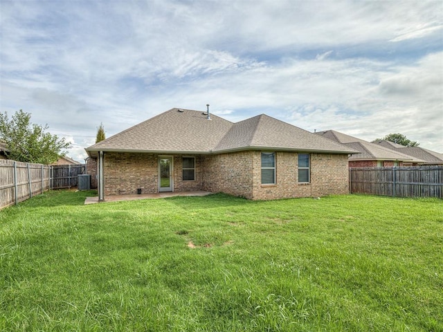 8612 SW 36th Ter, Oklahoma City, OK 73179 - back of property featuring a fenced backyard, a patio, brick siding, and a shingled roof