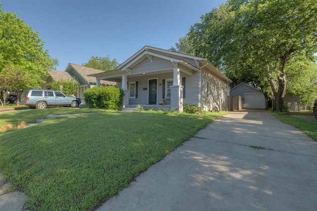 615 NW 26th St, Oklahoma City, OK 73103 - view of front facade with a porch, a garage, concrete driveway, and a front lawn