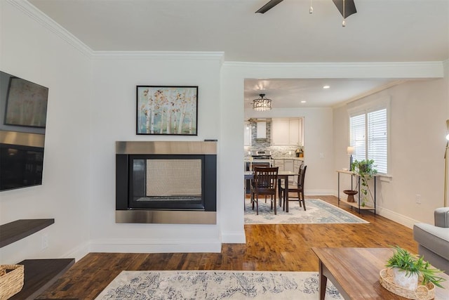 615 NW 26th St, Oklahoma City, OK 73103 - living room featuring ornamental molding, wood finished floors, a glass covered fireplace, a ceiling fan, and recessed lighting
