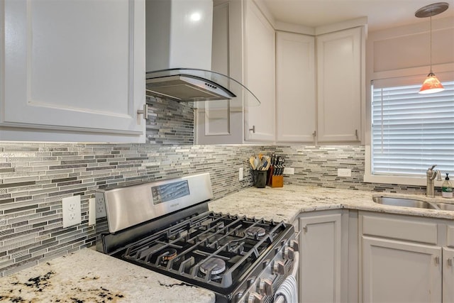 615 NW 26th St, Oklahoma City, OK 73103 - kitchen featuring gas stove, extractor fan, backsplash, and white cabinets