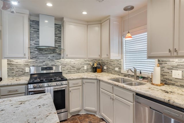 615 NW 26th St, Oklahoma City, OK 73103 - kitchen featuring appliances with stainless steel finishes, wall chimney range hood, white cabinets, tasteful backsplash, and recessed lighting