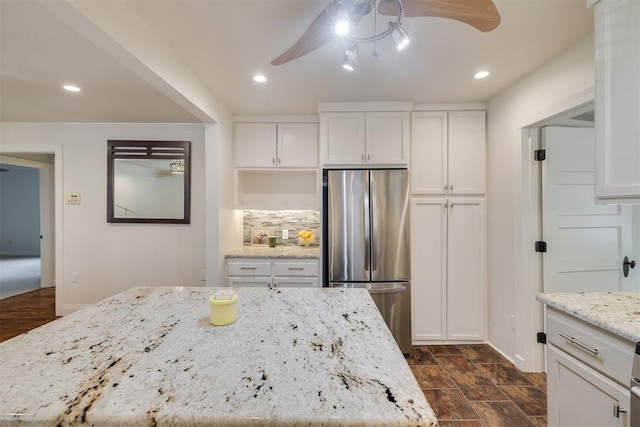 615 NW 26th St, Oklahoma City, OK 73103 - kitchen featuring freestanding refrigerator, ceiling fan, white cabinetry, light stone countertops, and recessed lighting