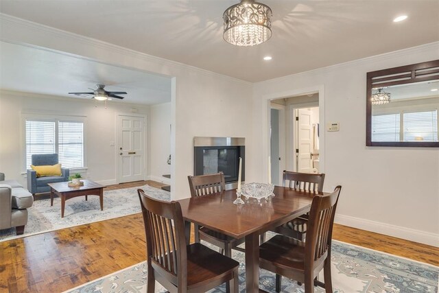 615 NW 26th St, Oklahoma City, OK 73103 - dining space featuring wood finished floors, crown molding, a chandelier, recessed lighting, and a ceiling fan