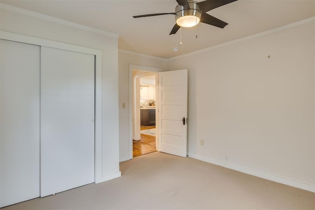 615 NW 26th St, Oklahoma City, OK 73103 - unfurnished bedroom featuring light carpet, ornamental molding, a closet, and a ceiling fan