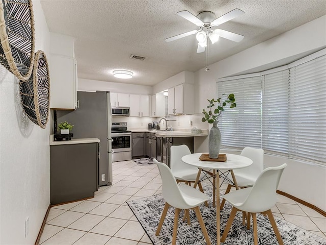 501 E Cardinal Pl, Midwest City, OK 73130 - dining room featuring a textured ceiling, light tile patterned floors, and a ceiling fan