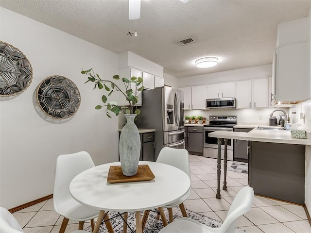 501 E Cardinal Pl, Midwest City, OK 73130 - dining room with a textured ceiling, light tile patterned flooring, and ceiling fan