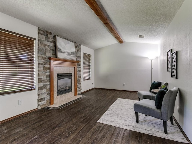501 E Cardinal Pl, Midwest City, OK 73130 - sitting room with a textured ceiling, a tiled fireplace, and wood finished floors