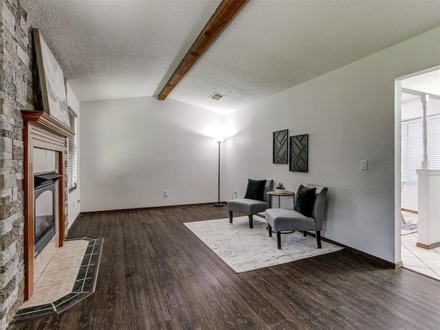 501 E Cardinal Pl, Midwest City, OK 73130 - sitting room with a tiled fireplace, wood finished floors, and a textured ceiling