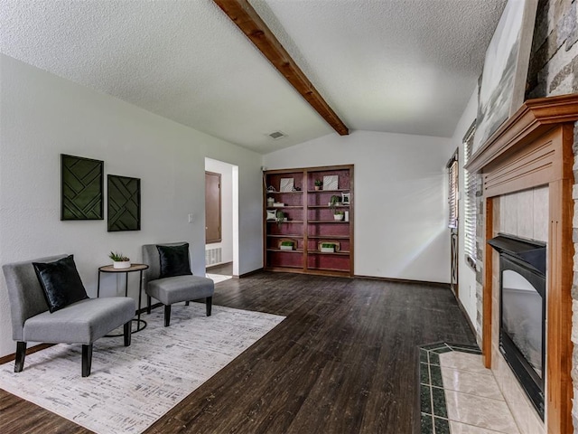 501 E Cardinal Pl, Midwest City, OK 73130 - sitting room featuring a tiled fireplace, a textured ceiling, and wood finished floors