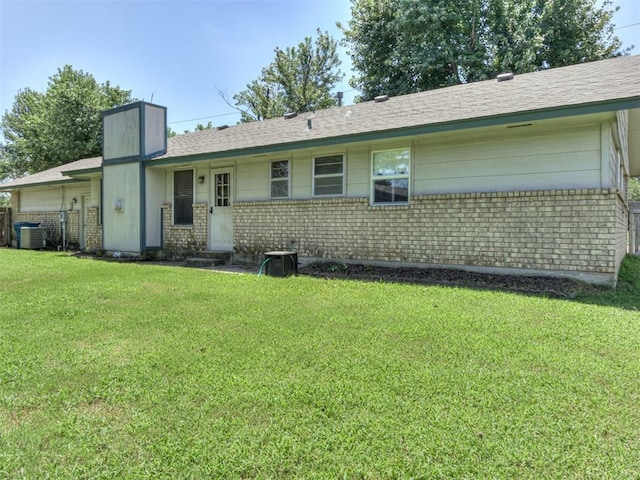 501 E Cardinal Pl, Midwest City, OK 73130 - view of front of house with brick siding, a front lawn, and roof with shingles