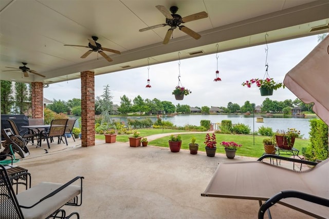 8404 NW 65th Pl, Oklahoma City, OK 73132 - view of patio / terrace with a ceiling fan, a water view, and outdoor dining space