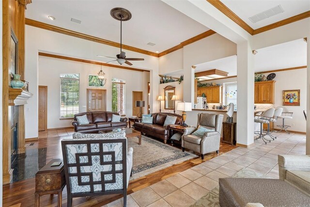 8404 NW 65th Pl, Oklahoma City, OK 73132 - living area featuring ornamental molding, ceiling fan, a high end fireplace, and a towering ceiling