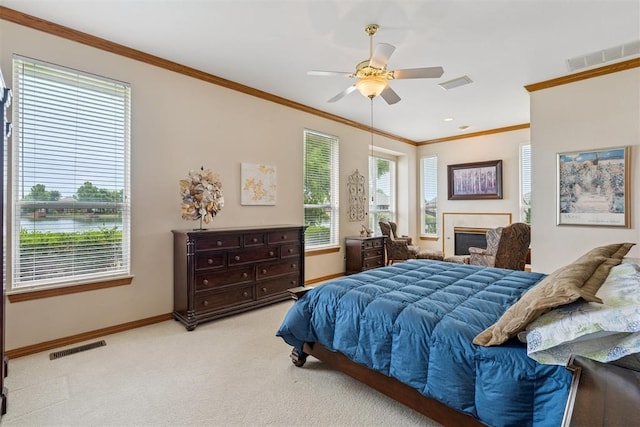 8404 NW 65th Pl, Oklahoma City, OK 73132 - bedroom with ornamental molding, carpet floors, a fireplace, and ceiling fan