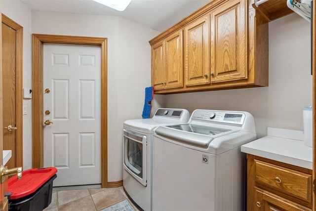 8404 NW 65th Pl, Oklahoma City, OK 73132 - laundry room with cabinet space, washing machine and clothes dryer, and light tile patterned floors