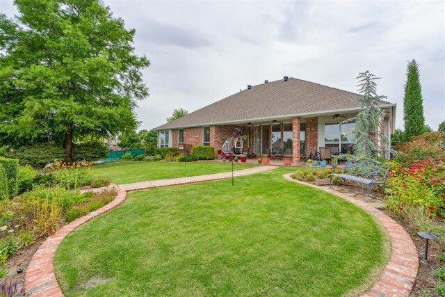 8404 NW 65th Pl, Oklahoma City, OK 73132 - rear view of property featuring a ceiling fan, a shingled roof, and brick siding