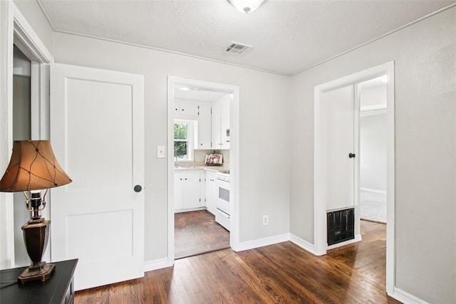 3213 SE 20th St, Del City, OK 73115 - hall with dark wood-style flooring and a textured ceiling