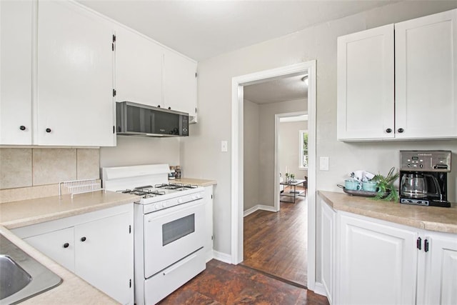 3213 SE 20th St, Del City, OK 73115 - kitchen with white range with gas stovetop, white cabinetry, light countertops, and decorative backsplash