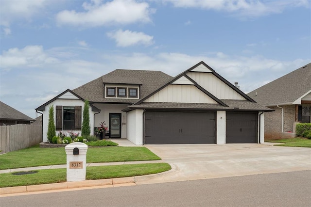 8317 Poplar Dr, Edmond, OK 73034 - view of front facade with a garage, roof with shingles, driveway, and board and batten siding