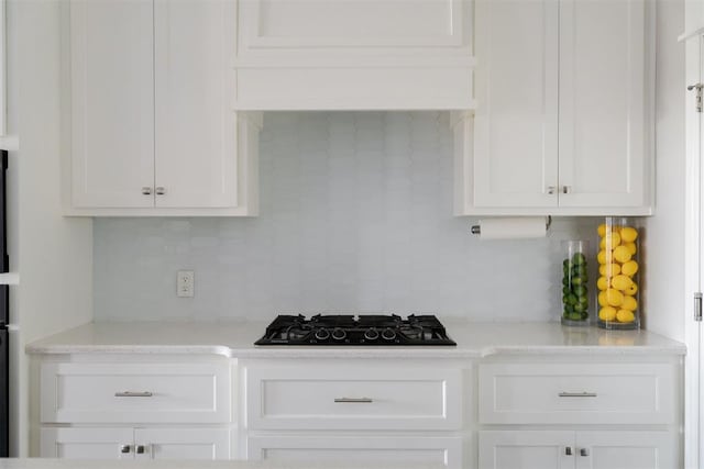 8317 Poplar Dr, Edmond, OK 73034 - kitchen with black gas cooktop, decorative backsplash, and white cabinetry
