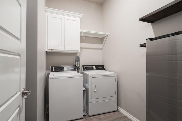 8317 Poplar Dr, Edmond, OK 73034 - laundry area featuring cabinet space, washing machine and dryer, and light wood finished floors