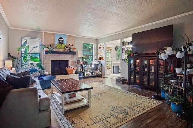 1713 Apian Way, Edmond, OK 73003 - living room with a brick fireplace, a textured ceiling, wood finished floors, and crown molding