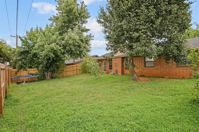1713 Apian Way, Edmond, OK 73003 - fenced backyard featuring a trampoline