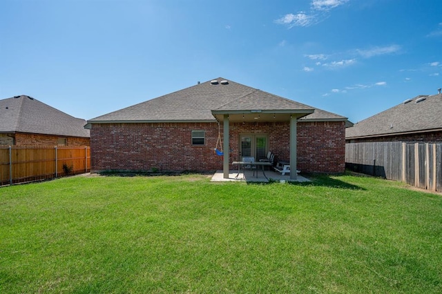 321 SW 147th St, Oklahoma City, OK 73160 - rear view of property featuring a fenced backyard, a patio area, brick siding, and roof with shingles