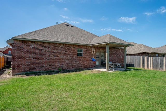 321 SW 147th St, Oklahoma City, OK 73160 - back of house with a fenced backyard, brick siding, a shingled roof, a patio area, and french doors