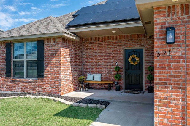 321 SW 147th St, Oklahoma City, OK 73160 - entrance to property with brick siding, solar panels, and a shingled roof
