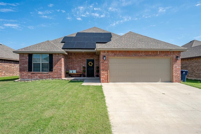 321 SW 147th St, Oklahoma City, OK 73160 - view of front facade with roof with shingles, brick siding, a front lawn, and solar panels